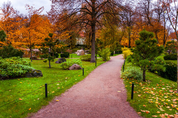 Fototapeta na wymiar Path leading to the Japanese garden in Kadriorg park. Autumn landscape. Tallinn, Estonia.