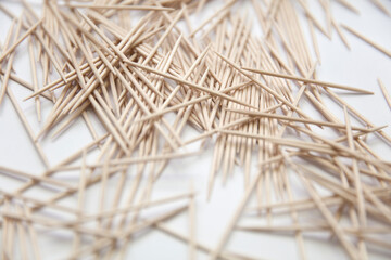 Chaotic pile of toothpicks on a white background