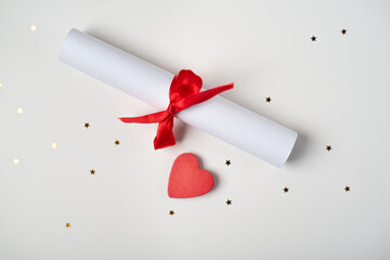 Valentine Day love letter tied with red ribbon and heart on light background. Valentine's day...