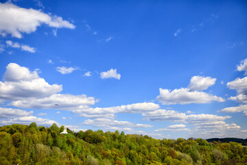 Obraz premium Vilnius. Lithuania. A view of the hill with the temple and the flying plane on a clear spring day.