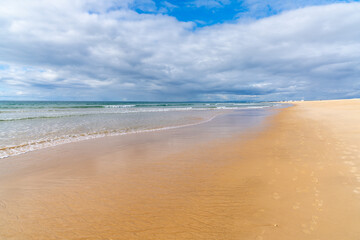 beautiful wide empty golden sand beach