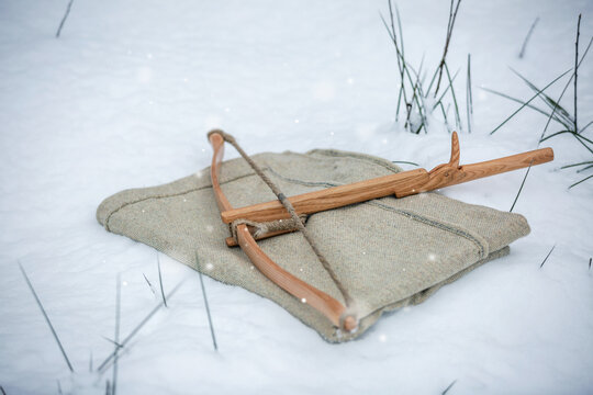 Wooden medieval European crossbow in the snow
