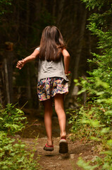 girl running along the path in the forest