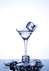 A wineglass of water and ice cubes