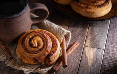 Baked Cinnamon Roll and Cup of Coffee