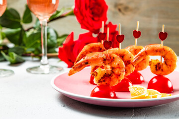  Fried shrimp, roses and champagne on the table. Original food for Valentine's Day, romantic dinner. Top view, free space for text