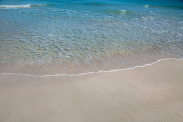 Sandy shore washed by a gentle clear sea