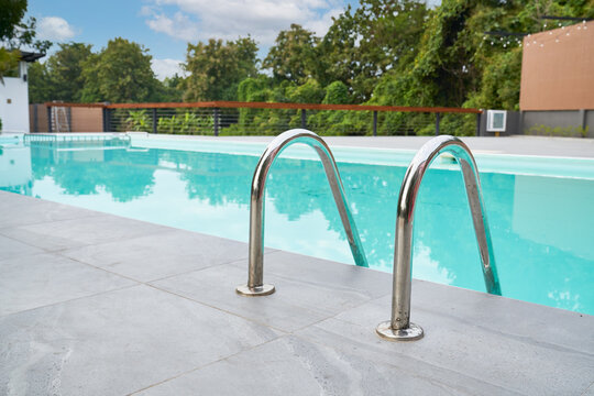 Swimming pool with green trees background