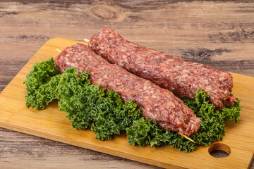 Raw minced beef kebab skewer