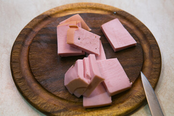The process of cooking scrambled eggs with lard and sausage. The man prepares two portions. Sausage...