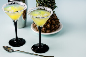 Tasty Pineapple Cocktail or Juice in Glasses with Ice Cube Healthy Drink Blue Background Horizontal Copy Space