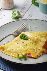 Omelette with ham and cheese on the plate