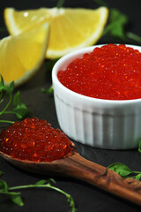 A small ceramic bowl with red caviar