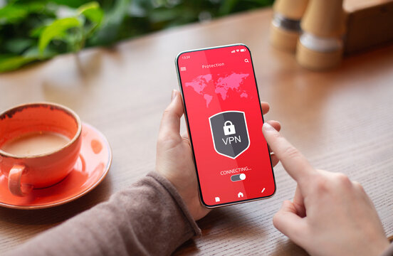 Woman holding and using smartphone with vpn app