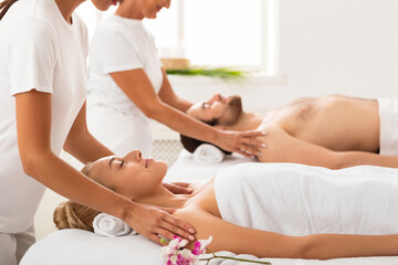 Fototapeta na wymiar Wife And Husband Enjoying Shoulders Massage At Spa Resort