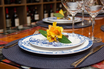 Dining table with bowls and dishes set for dinner and wine tasting.