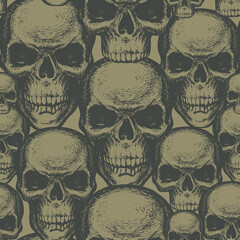 Seamless pattern with hand-drawn human skulls in retro style. Vector background with sinister skulls on a khaki backdrop. Graphic print for clothes, fabric, wallpaper, wrapping paper