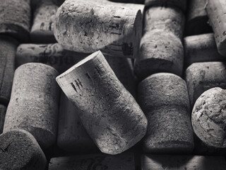 Corks from wine and champagne bottles fill the frame in black and white