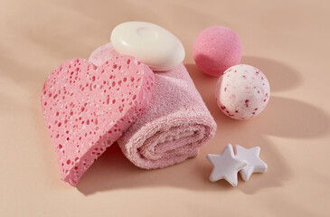 Aromatherapy concept with pink sponge, towel, soap and bath salt