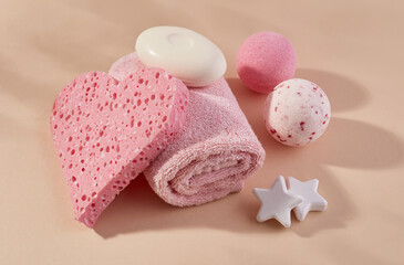 Aromatherapy concept with pink sponge, towel, soap and bath salt