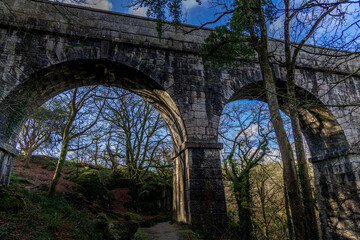 Fototapeta na wymiar The huge arches of Luxulyan viaduct, Cornwall set against a blue winter sky