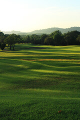 Beautiful golf course at the sunset, sunrise time.