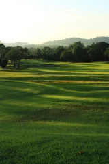 Foto op Plexiglas Beautiful golf course at the sunset, sunrise time. © sittinan