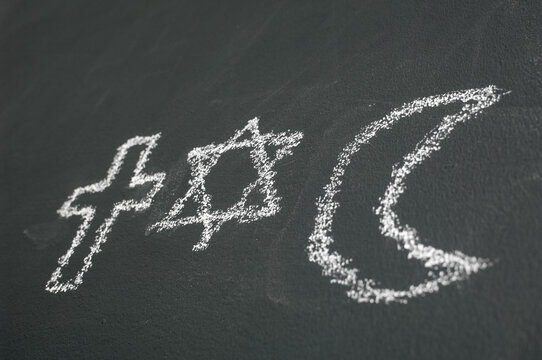 Star of David, Cross and Islamic Crescent on a blackboard