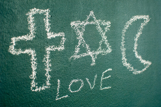 Star of David, Cross and Islamic Crescent on a blackboard