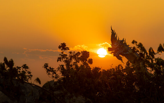 The sun rises statue of Naka Buddha and large Buddha statue at Mukdahan Province,Big Buddha Wat Phu Manorom Mukdahan Thailand.