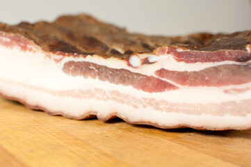 Smoked bacon on wooden background