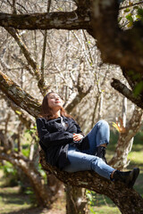 Portrait of Asian young woman enjoying plum blossom garden in the spring.