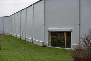 Fototapeta na wymiar Exterior walls of a grey warehouse.