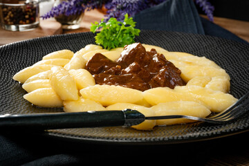 Beef stew in gravy, served with potato dumplings.