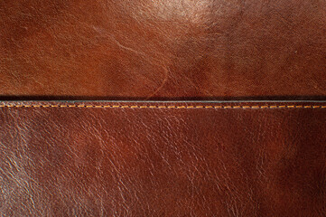 Dark brown leather texture with seam