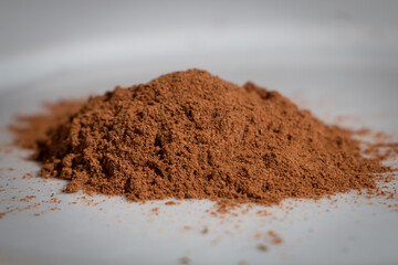 Ground nutmeg in a heap, ready to use in tasty dishes