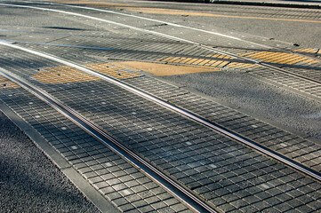 Naklejka na ściany i meble Tram lines intersection on the paved street