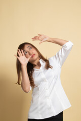 Naklejka premium Excited young Asian woman look up.