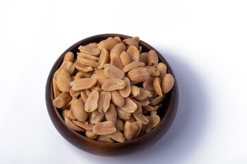 Peanuts in a wooden cup on a white background