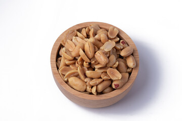 Peanuts in a wooden cup on a white background