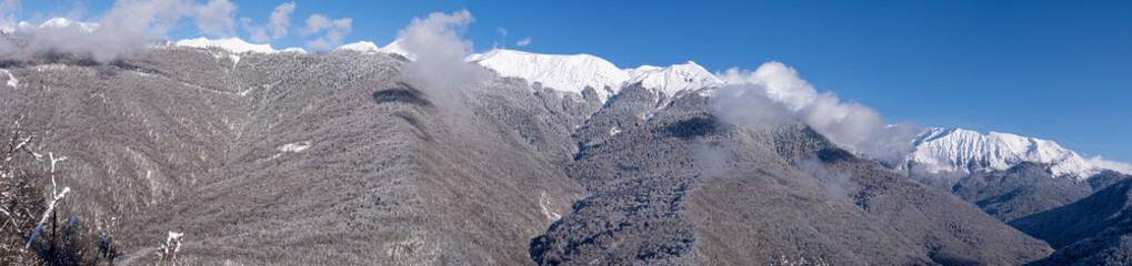 Winter   mountains panorama with snow and clouds.