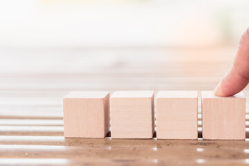The four wooden blocks for add text, icon or pictures, For design or art work to insert texts or word about Education, Business, Icon, Design, Idea, Nature and day light background, Selective focus.