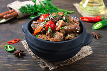 Delicious dietary liver roasted with cherry tomatoes. Roast meal in a pot.