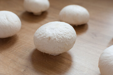 Champignons at wooden background