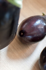 Purple eggplants or aubergine on wooden background