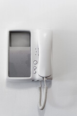 A video entry phone on white wall