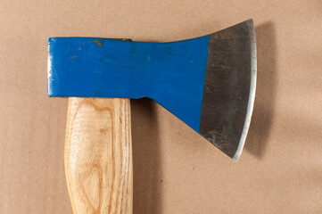 Small hand axe with wooden handle isolated on cardboard paper