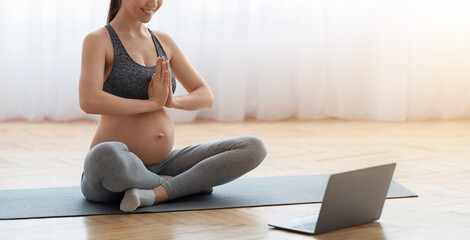 Online Yoga For Pregnant. Expecting Young Woman Training At Home With Laptop