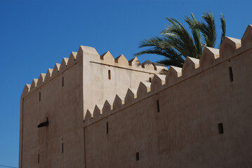 Crenellated walls of an Omani castle near Nizwa .