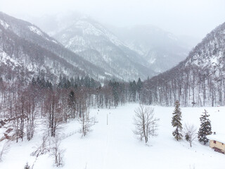 During the snowfall in the mountains. View from above.